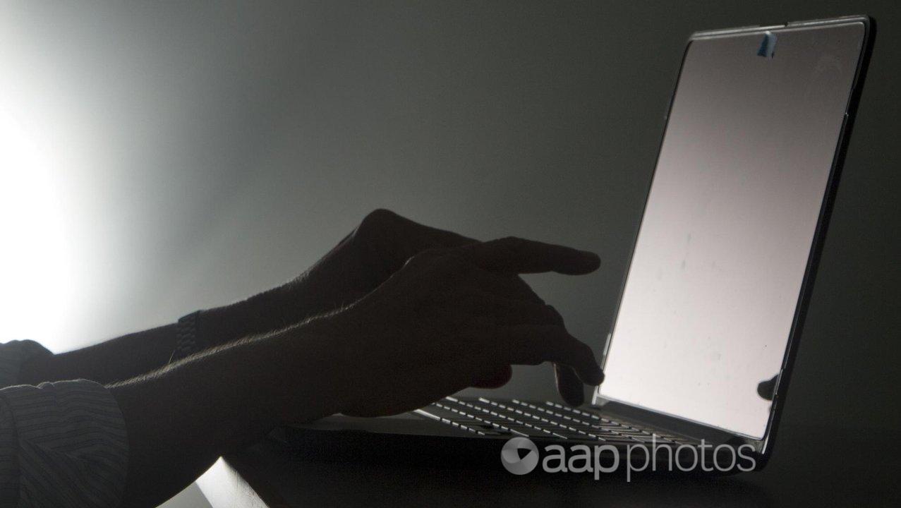 A file picture of a woman typing on a laptop.
