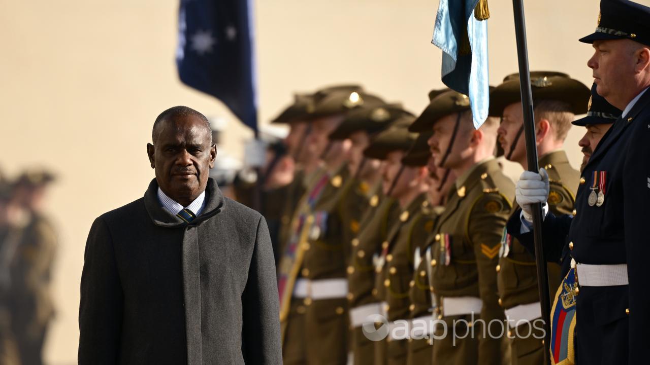 Solomon Islands PM Jeremiah Manele inspects a guard of honour