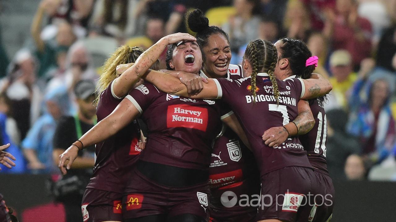 Tazmin Rapana (centre) celebrates her late try for Queensland.